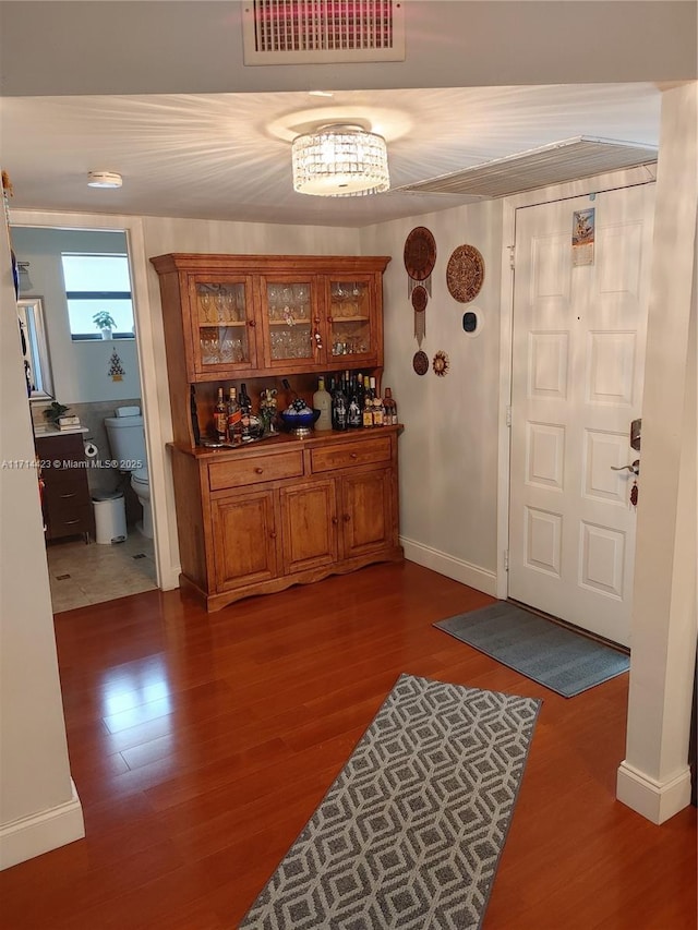 bar with wood-type flooring