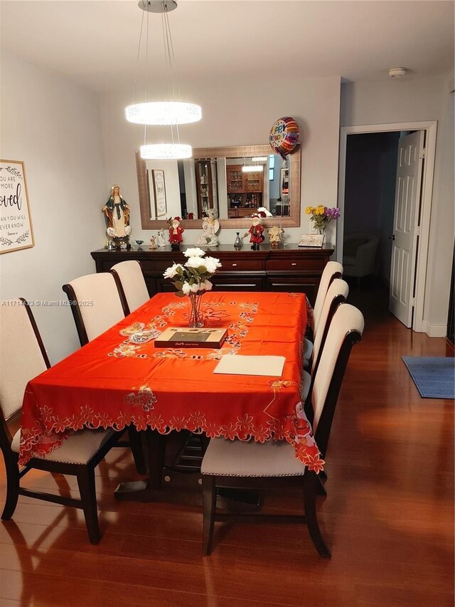 dining space with hardwood / wood-style flooring