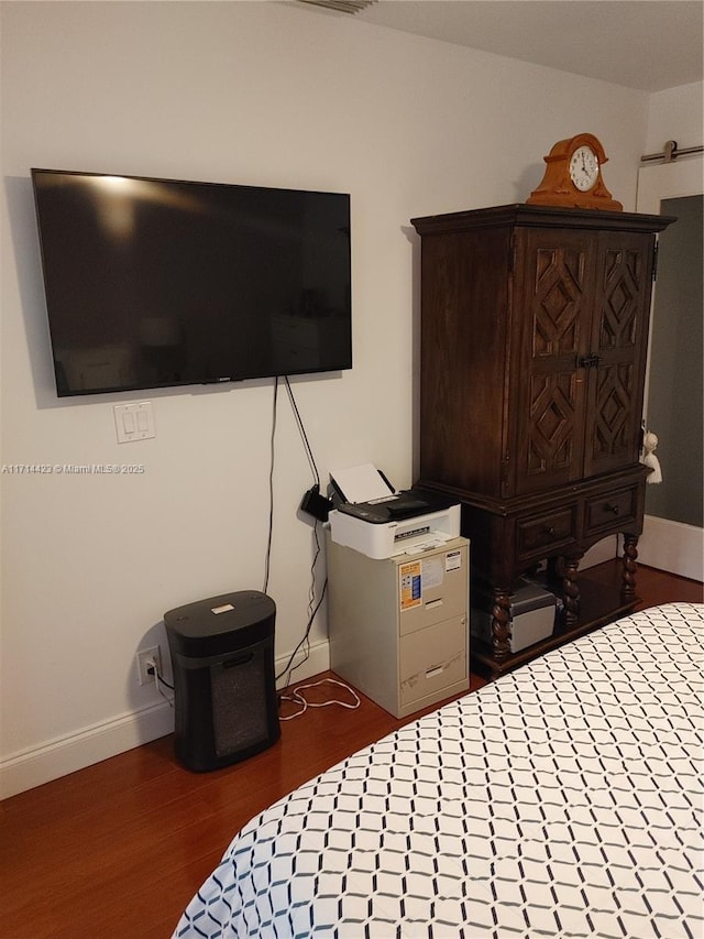 bedroom featuring dark hardwood / wood-style flooring