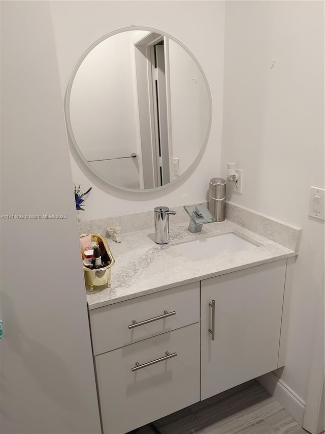 bathroom with wood-type flooring and vanity