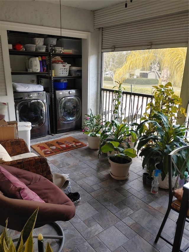 clothes washing area featuring washer and clothes dryer