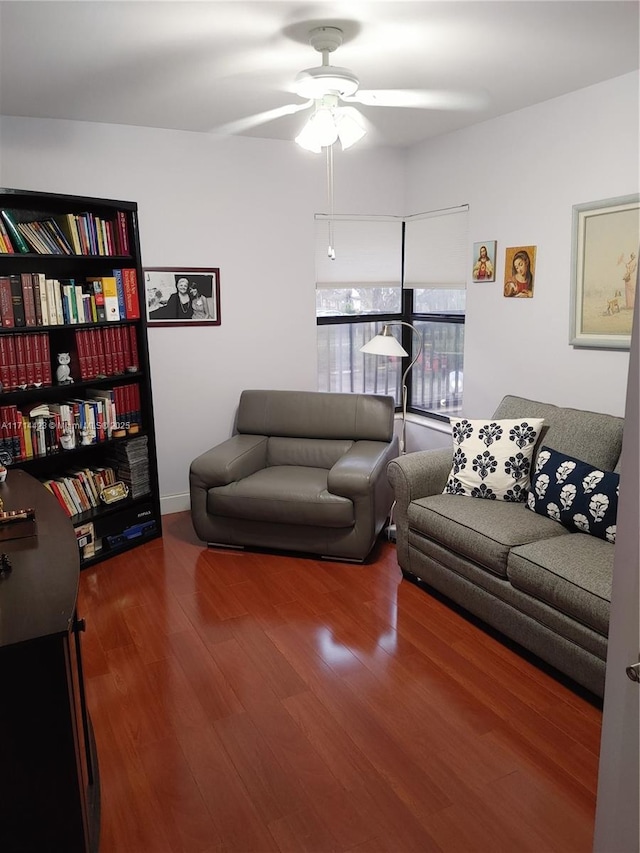 living room featuring hardwood / wood-style floors and ceiling fan