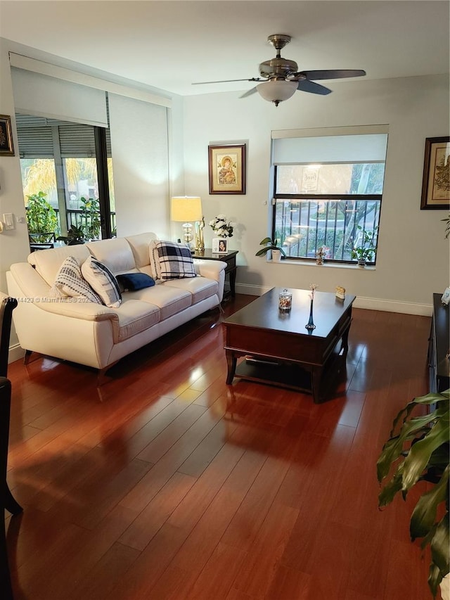 living room with ceiling fan, plenty of natural light, and dark hardwood / wood-style floors