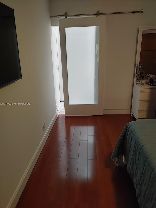 bedroom with dark hardwood / wood-style flooring