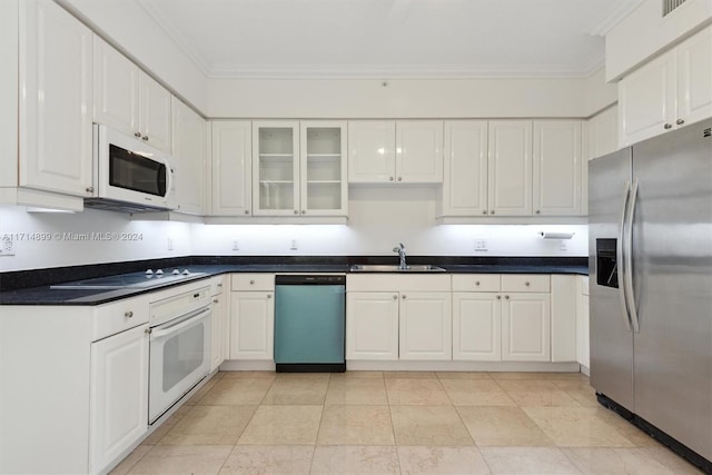 kitchen featuring white cabinetry, sink, appliances with stainless steel finishes, and ornamental molding