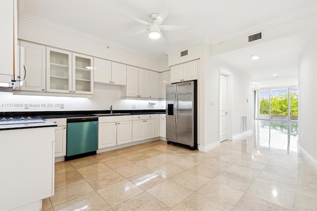 kitchen with white cabinets, ceiling fan, sink, and stainless steel appliances