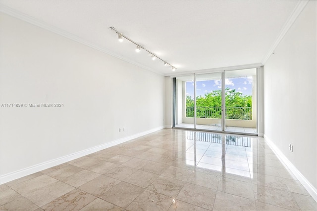 spare room with a wall of windows and ornamental molding