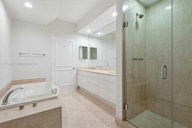 bathroom with tile patterned flooring, vanity, and separate shower and tub