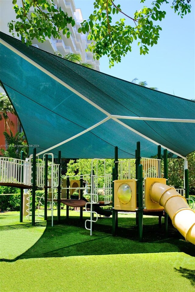 view of property's community featuring a playground and a lawn