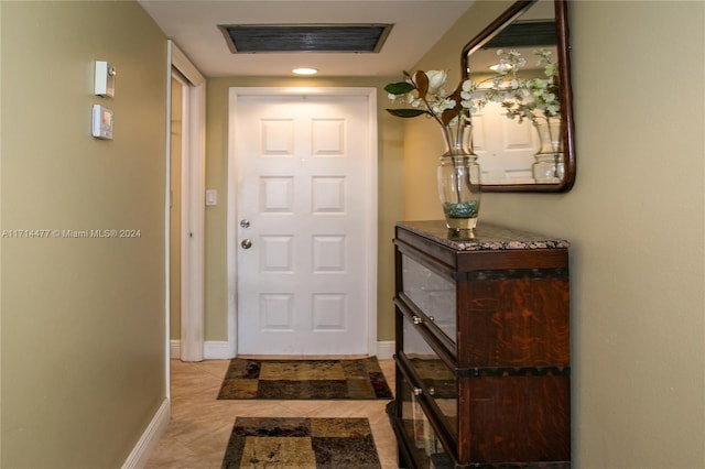 doorway to outside featuring light tile patterned flooring