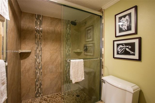 bathroom with toilet, ornamental molding, and walk in shower