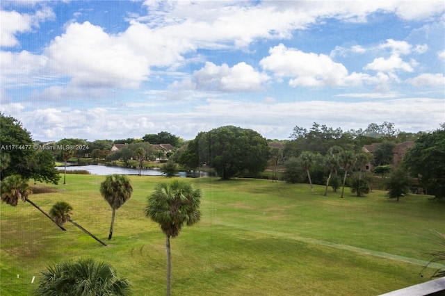 view of property's community featuring a water view and a yard