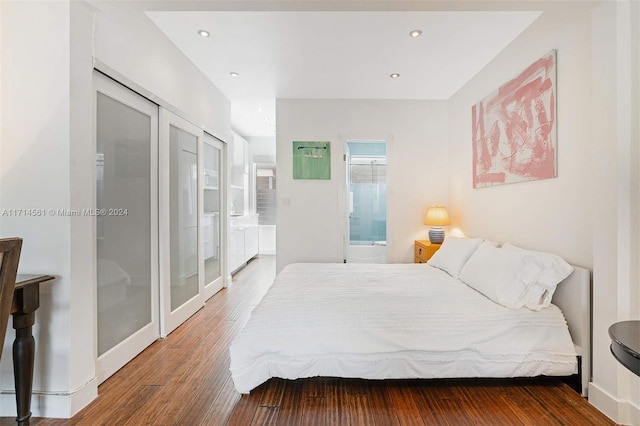 bedroom with wood-type flooring and a closet