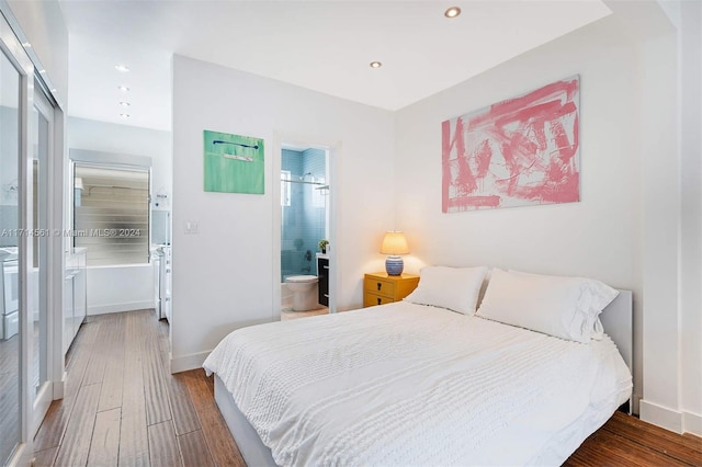 bedroom with ensuite bathroom and wood-type flooring