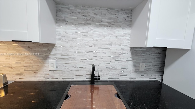 kitchen featuring backsplash and white cabinetry