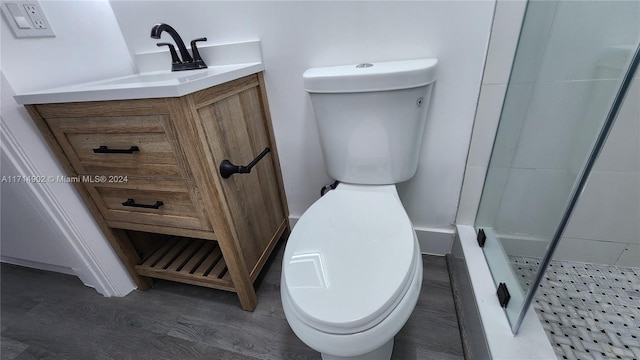 bathroom with vanity, toilet, and a shower