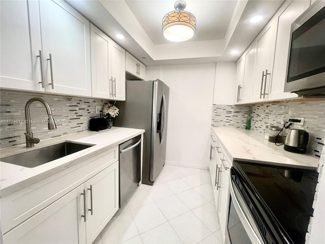 250 174th St Unit 2307, Sunny Isles Beach, FL 33160 - kitchen featuring stainless steel appliances, white cabinetry, tasteful backsplash, light stone countertops, and recessed lighting