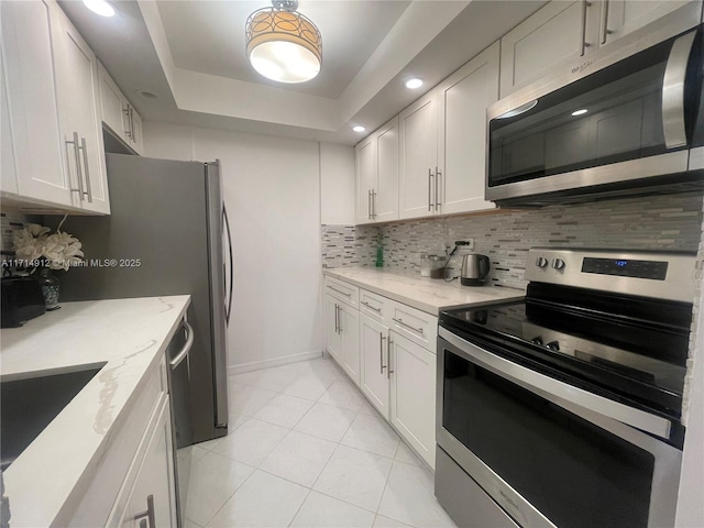 250 174th St Unit 2307, Sunny Isles Beach, FL 33160 - kitchen with appliances with stainless steel finishes, tasteful backsplash, light stone countertops, and recessed lighting