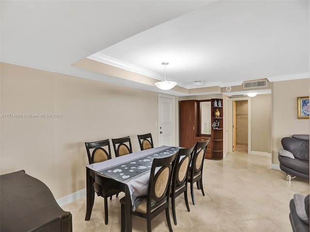 dining room with crown molding and a tray ceiling