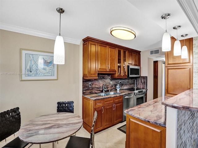 kitchen with hanging light fixtures, backsplash, a breakfast bar area, light tile patterned floors, and appliances with stainless steel finishes