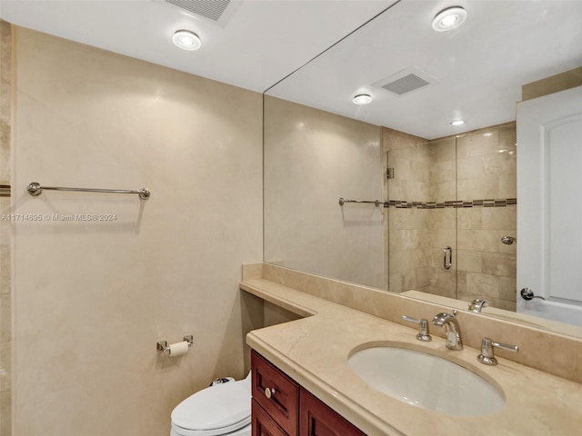 bathroom with vanity, toilet, and walk in shower