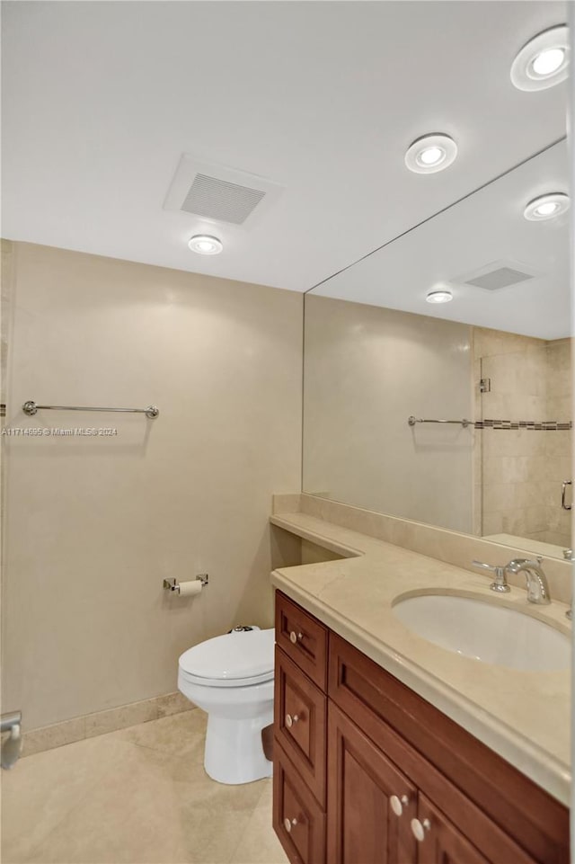 bathroom with tile patterned flooring, vanity, and toilet