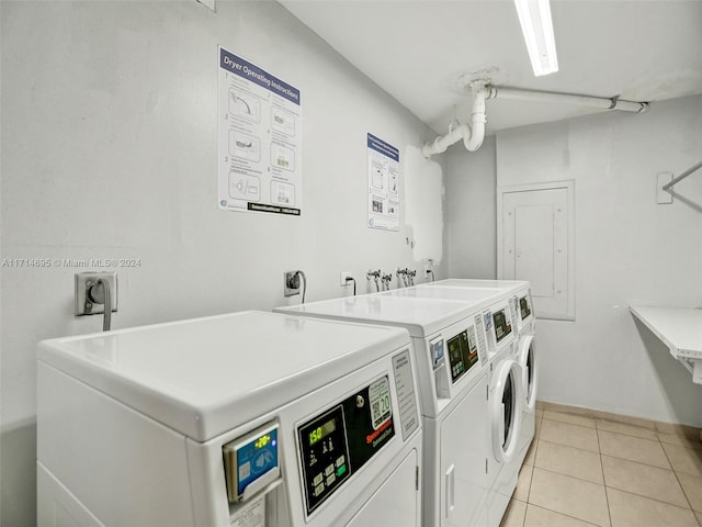 washroom with light tile patterned floors and washer and clothes dryer