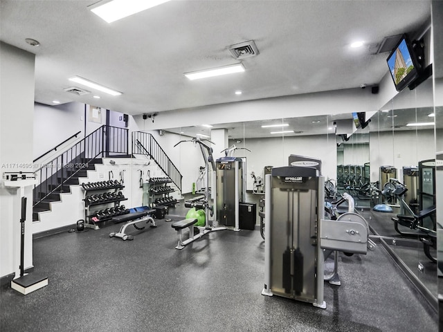 gym featuring a textured ceiling