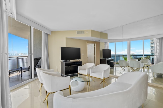 living room featuring floor to ceiling windows and light tile patterned flooring