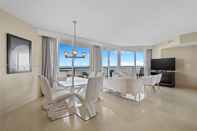 dining room featuring a chandelier, light tile patterned floors, and expansive windows