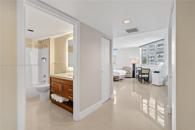 full bathroom featuring tile patterned flooring, vanity, toilet, and tiled shower / bath