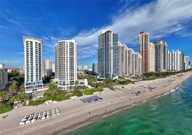 exterior space with a water view and a beach view