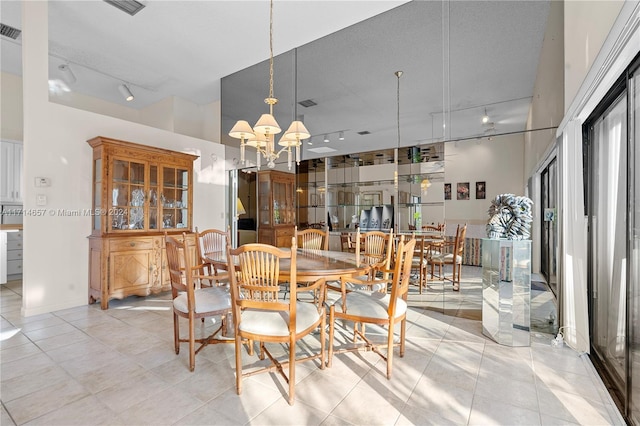 tiled dining space featuring a notable chandelier