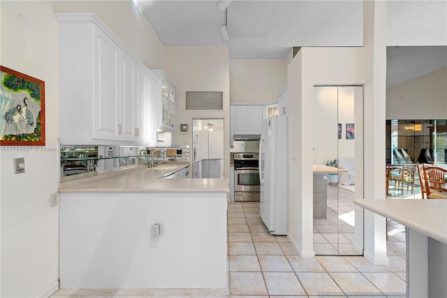 kitchen featuring white cabinets, white refrigerator, stainless steel stove, and sink