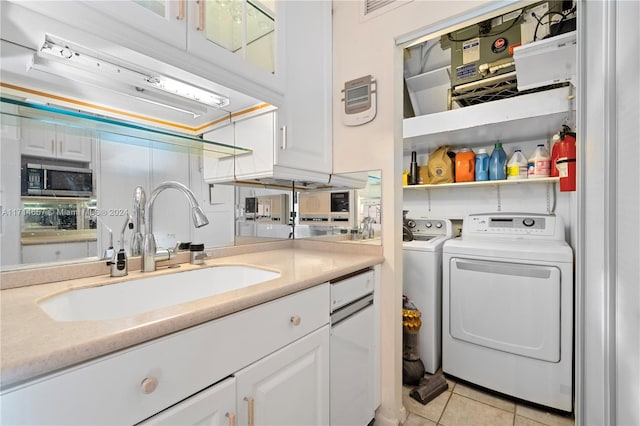 laundry room featuring separate washer and dryer, sink, and light tile patterned floors