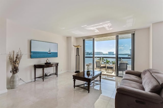 living room with expansive windows, a water view, and light tile patterned flooring