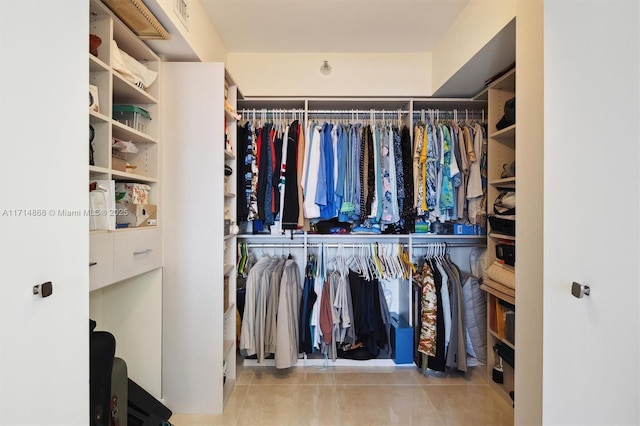 spacious closet featuring light tile patterned floors