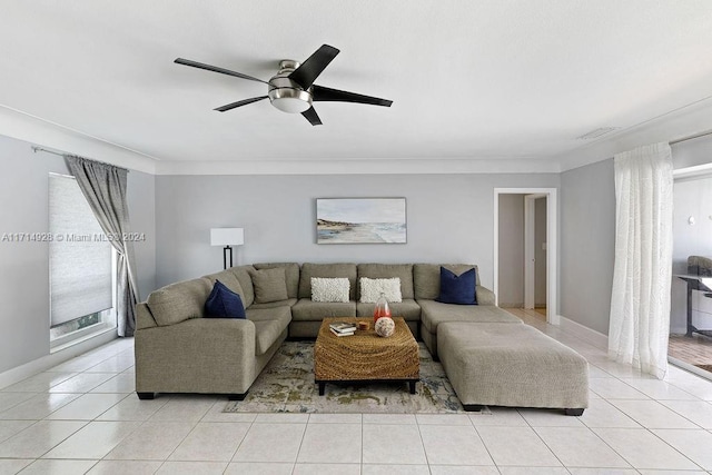 tiled living room with ceiling fan, a healthy amount of sunlight, and ornamental molding