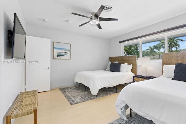 bedroom with wood-type flooring and ceiling fan