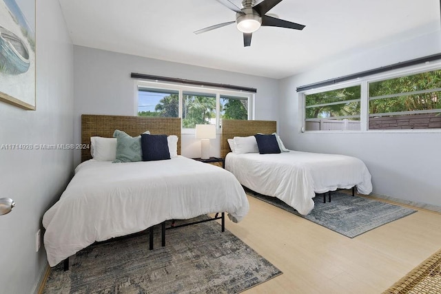 bedroom with ceiling fan and hardwood / wood-style floors