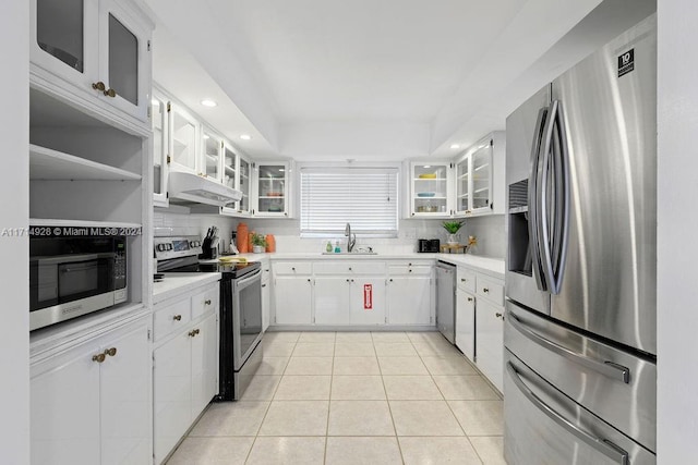 kitchen featuring white cabinets, light tile patterned flooring, sink, and appliances with stainless steel finishes