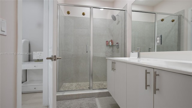 bathroom featuring vanity and a shower with shower door