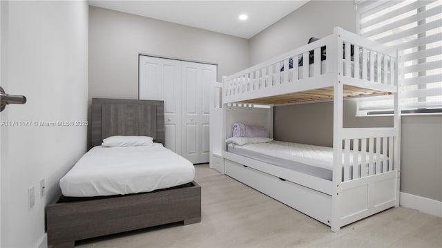 bedroom featuring a closet and light hardwood / wood-style flooring