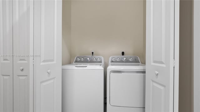 laundry area with separate washer and dryer