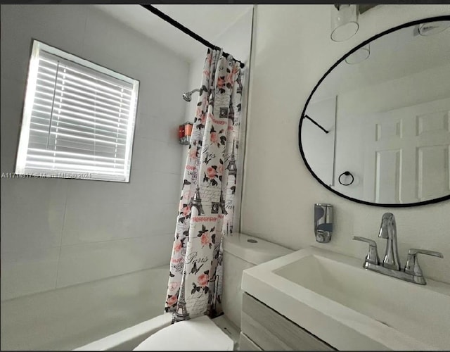 full bathroom featuring vanity, toilet, and shower / bath combo with shower curtain