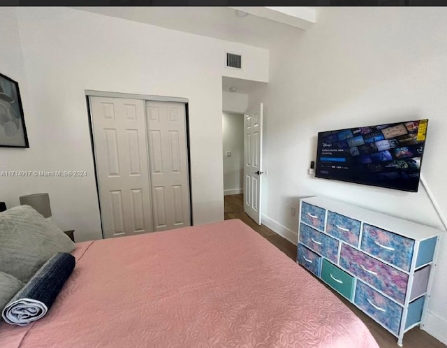 bedroom featuring dark hardwood / wood-style flooring and a closet