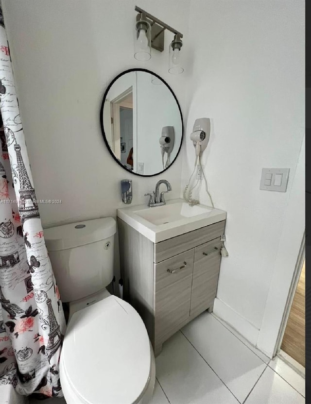 bathroom with tile patterned floors, vanity, and toilet