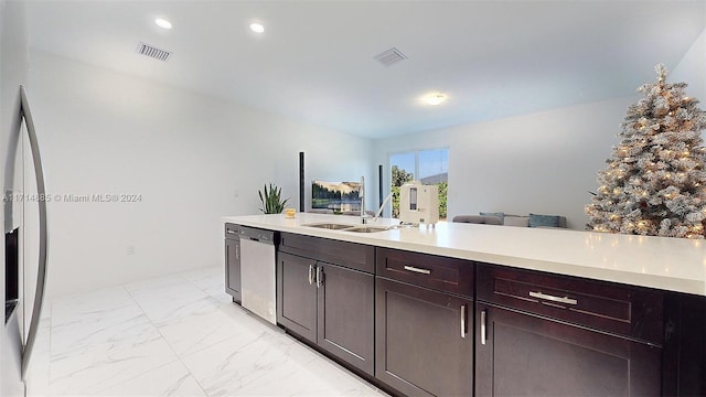 kitchen with dishwasher, dark brown cabinets, and sink