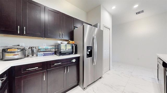 kitchen featuring dark brown cabinets and stainless steel refrigerator with ice dispenser