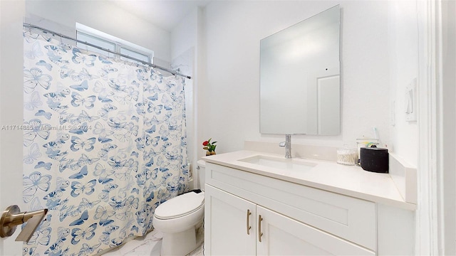 bathroom with curtained shower, vanity, and toilet